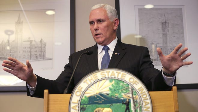 Governor Mike Pence talks to the media about the putting a halt to the Syrian refugee program Tuesday, December 8, 2015, afternoon at Signature Flight Support at the Indianapolis Airport.