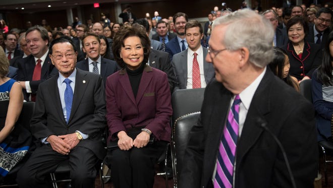 Elaine Chao, nominee for secretary of Transportation, arrives and sits with her father James Chao, as her husband Sen. Mitch McConnell, R-Ky., turns to see his wife before he would speak in support of the nominee during her confirmation hearing before the Senate Commerce, Science, and Transportation Committee on Jan 11, 2017.