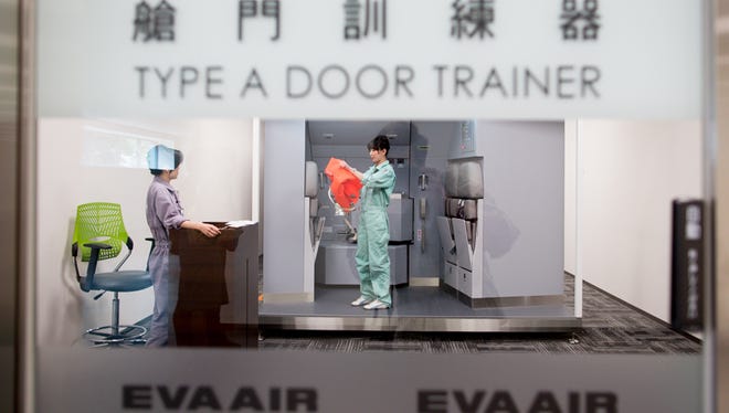 A flight attendant participates in a recurrent water-landing door training at EVA Air's sprawling training center, located outside of Taipei, Taiwan, on May 30, 2016.