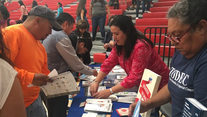 Volunteers from TODEC Legal Center and the Mexican Consulate in San Bernardino hand out information about immigration policies and legal rights.