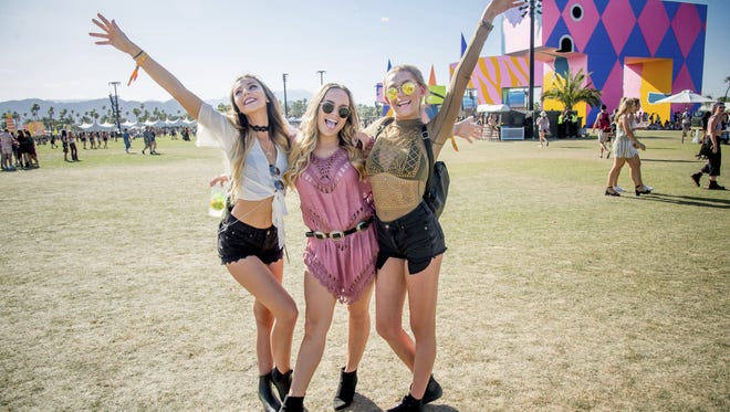 Festival goers pose at Coachella on April 15, 2017.