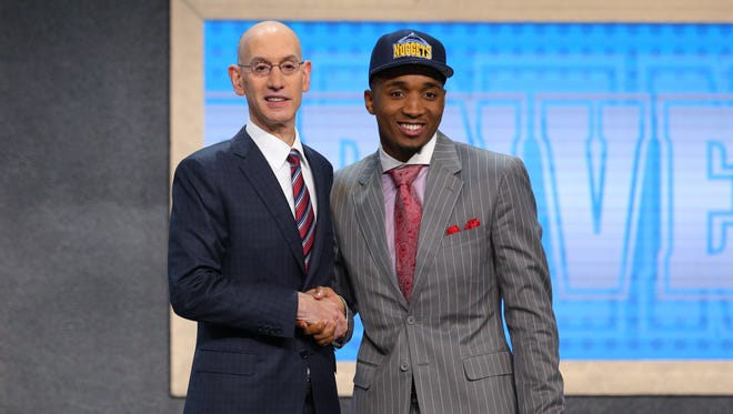 Donovan Mitchell (Louisville) is introduced by NBA commissioner Adam Silver as the No. 13 overall pick.