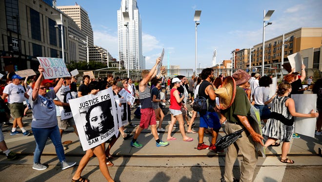 Demonstrators march on Walnut Street during a Countdown to Conviction Coalition rally for justice for Sam DuBose Saturday, July 22, 2017. Sam DuBose was unarmed when he was shot and killed during a traffic stop by former University of Cincinnati police officer Ray Tensing, July 19, 2015. Tensing was tried two times, both trials ended in hung juries.