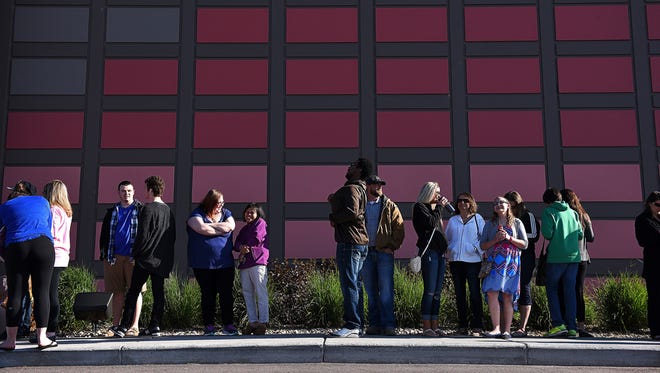People line up outside The District nightclub in May 2016 while waiting for President Bill Clinton to speak at a campaign event for Hillary Clinton.
