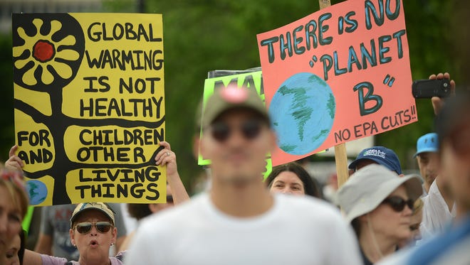 People gather near the U.S. Capitol for the People's Climate March before heading to the White House on April 29, 2017 in Washington, D.C.