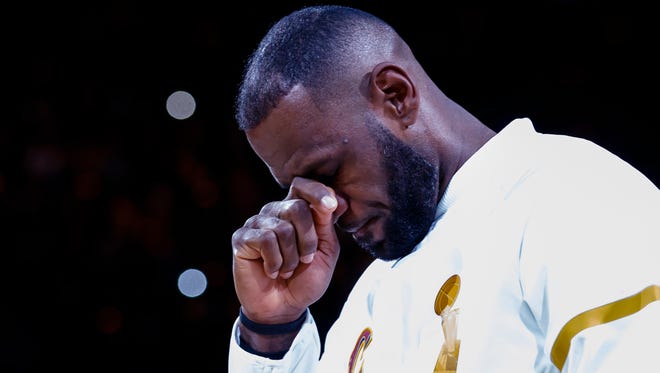 Cleveland Cavaliers forward LeBron James (23) reacts during the ring ceremony and banner raising ceremony before Tuesday's opening night.