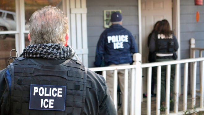 In this Feb. 9, 2017, photo provided U.S. Immigration and Customs Enforcement, ICE agents at a home in Atlanta, during a targeted enforcement operation aimed at immigration fugitives, re-entrants and at-large criminal aliens.
