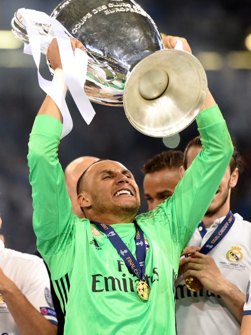 Real Madrid goalkeeper Keylor Navas lifts the trophy after the UEFA Champions League final.