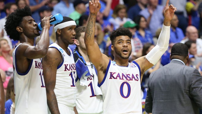 Kansas guard Frank Mason III celebrates on the bench at the end of the team's win against Michigan State.