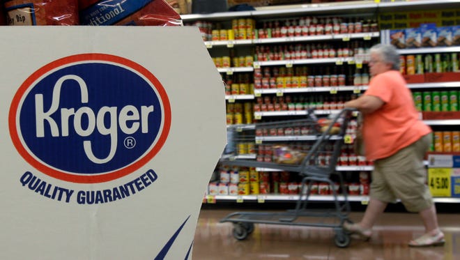 A shopper moves through a Kroger Co. supermarket in Newport, Ky. in this 2010 file photo
