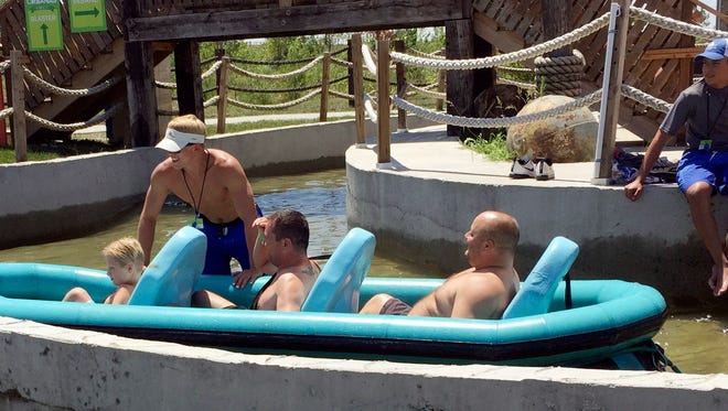 This July 26, 2016 photo, provided by Erin Oberhauser, shows her husband, Paul Oberhauser, in the back of the raft after riding the "Verruckt" raft ride at the Schlitterbahn WaterPark in Kansas City, Kan.
