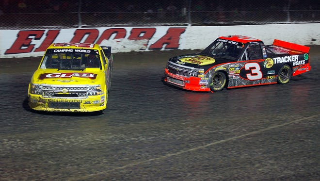 Kyle Larson, left, spins out in front of Ty Dillon (3) during the 2014 NASCAR Camping World Truck Series Mudsummer Classic at Eldora Speedway.