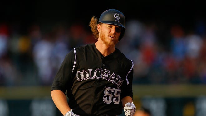 July 5: Rockies starter Jon Gray trots around the bases after hitting a 467-foot home run against the Reds.