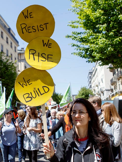 A protester holds a sign for the World Climate March in Geneva, Switzerland.