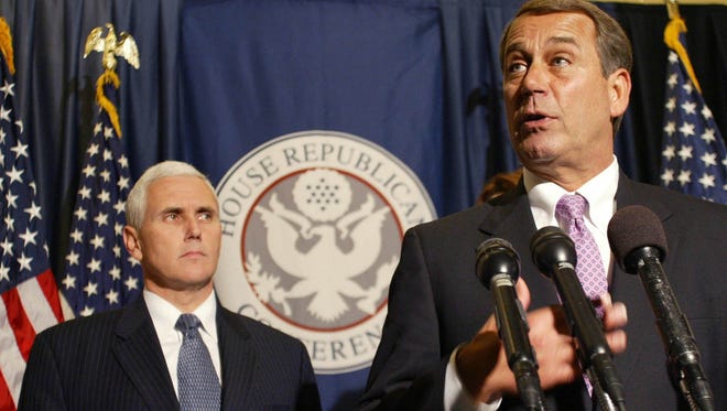 IN-PENCE -- GOP Conference Chairman Rep. Mike Pence, R-Ind., left, listens as Minority House Republican Leader John Boehner, R-Ohio, talks about the newly elected House Republican leadership at a news conference in Washington on Wednesday, Nov. 19, 2008. (Gannett News Service, Heather Wines)