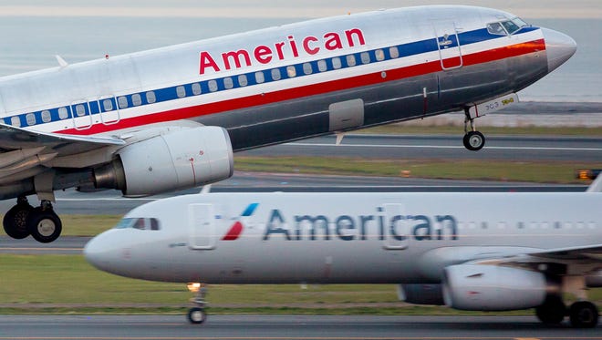 An American Airlines Boeing 737 takes off over a company Airbus A321 from Boston Logan International Airport on Nov. 14, 2016.