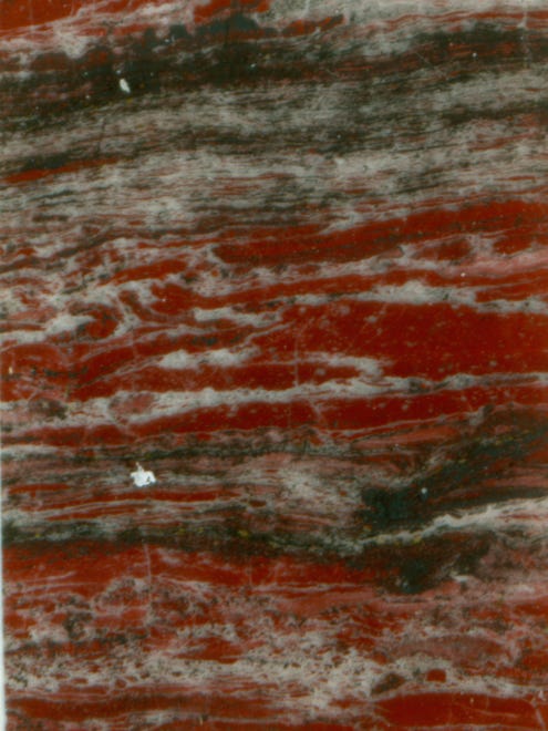 Layered haematite (red) and quartz (white) rock from the 480 million-year-old Løkken hydrothermal vent deposit, in Norway  a younger analogue for ancient habitats on early Earth and possibly elsewhere in the Solar System.