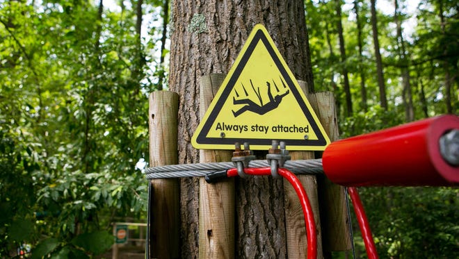Signs to always stay attached are posted throughout the Go Ape at Lums Pond which remains closed after the death of a Felton woman when she fell to her death Wednesday afternoon.