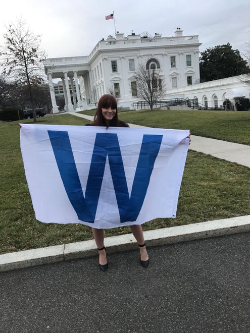 Cubs fan Melanie Zanona displays a W flag on the White House grounds."