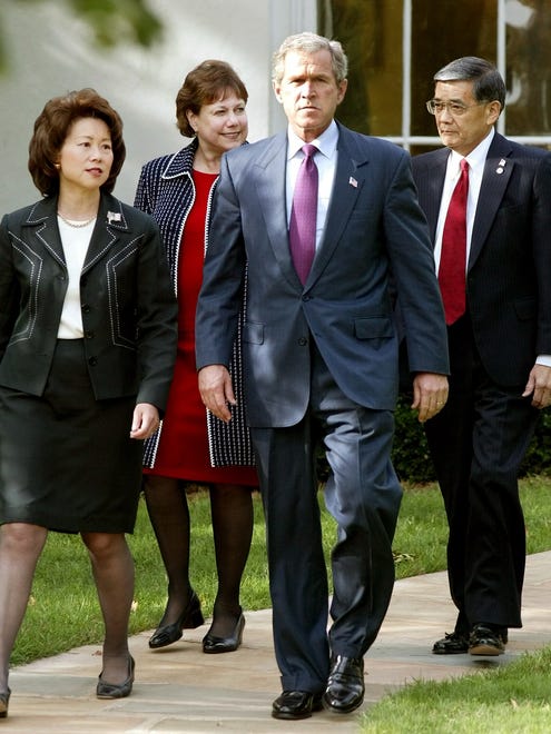 President George W. Bush walks out of the Oval Office, joined by Labor Secretary Elaine Chao, Agriculture Secretary Ann Veneman and Transportation Secretary Norman Mineta on Oct. 8, 2002, in Washington.