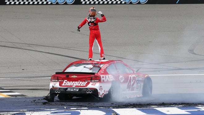 Kyle Larson celebrates on the roof of his No. 42 Chevrolet after winning at Michigan International Speedway.
