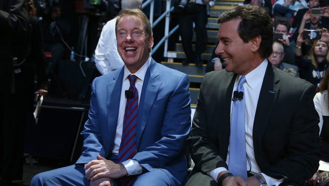 Bill Ford, the executive chairman of Ford Motor Company and Mark Fields, president and CEO of Ford laugh while having their picture taken by photographers at the 2016 North American International Auto Show.