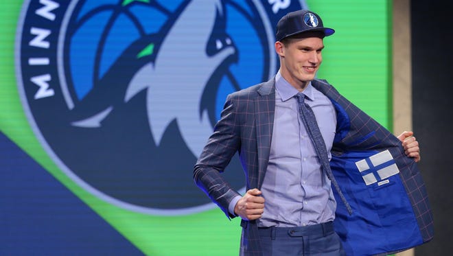 Lauri Markkanen (Arizona) shows off the inside of his suit jacket as he is introduced as the No. 7 overall pick.