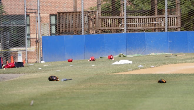 Baseball equipment is seen scattered on the field where a shooting took place at the practice of the Republican congressional baseball team at Eugene Simpson Stadium Park in Alexandria, Va.  The Republican House majority whip Steve Scalise and at least four others have been shot shot at a congressional baseball game practice session, according to media reports.