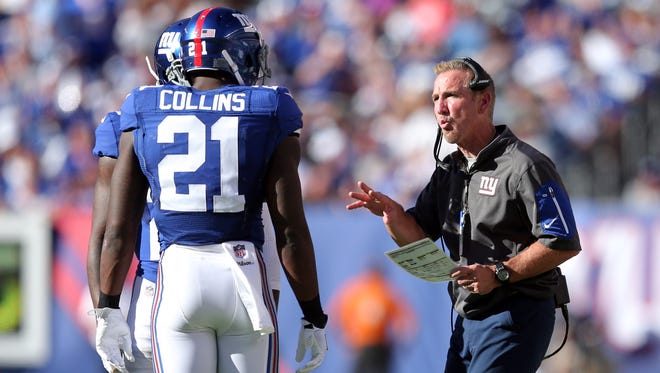 New York Giants defensive coordinator Steve Spagnuolo talks with New York Giants safety Landon Collins (21) and New York Giants corner back Janoris Jenkins (20) during the fourth quarter against the Washington Redskins at MetLife Stadium.