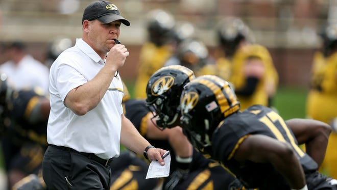 Missouri coach Barry Odom watches his players warm up before the team's spring game.