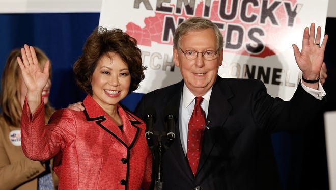 McConnell and Chao wave to supporters after a victory celebration following McConnell's win in the Republican Senate primary on May 20, 2014, in Louisville.