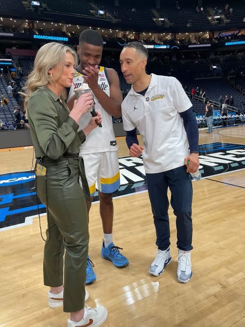 CBS Sports sideline reporter Jamie Erdahl enjoys a milkshake at the encouragement of Marquette men's basketball coach Shaka Smart and point guard Kam Jones after the Golden Eagles' 78-61 win in the NCAA Tournament first round on Friday, March 17, 2023. Erdahl brought out the milkshake for the interview because Smart has a tradition of treating the team to milkshakes after road victories.
