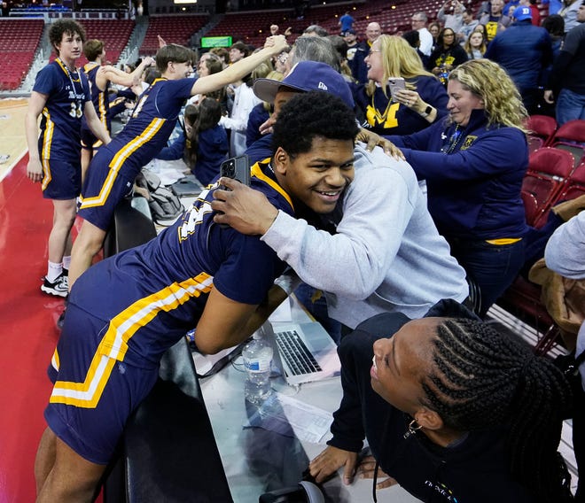Marquette players celebrate with their families after their victory over Arrowhead in the WIAA Division 1 boys basketball state championship game on Saturday March 16, 2024 at the Kohl Center in Madison, Wis.