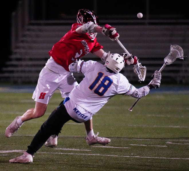 Homestead's Sean West (3) levels Mukwonago's Ollie Kettle (18) during the lacrosse match at Mukwonago on Tuesday, March 19, 2024. West was flagged for an illegal body check.