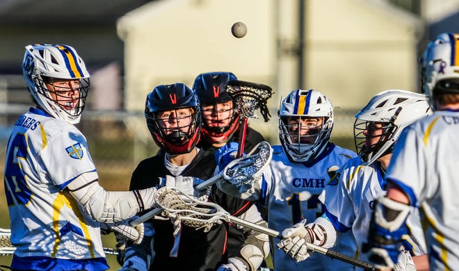 Players battle for possession during the boys lacrosse match between Catholic Memorial and Cedarburg in Waukesha on Wednesday, March 20, 2024.