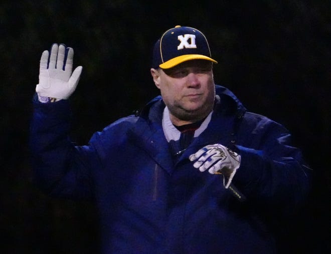 Pius XI head coach Kevin Kehoss gives a signal during the game against Waukesha South at Frame Park in Waukesha, Thursday, March 28, 2024.