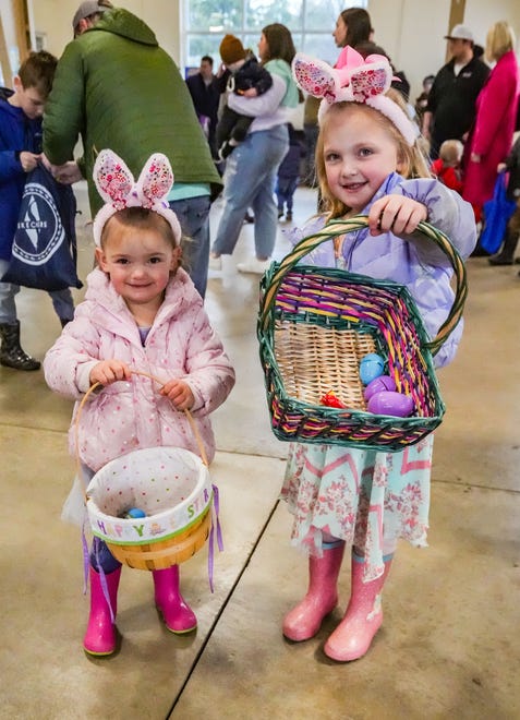 Clara, 2, and Scarlette Monaghan, 5, of Oconomowoc, display their candy-filled egg collections during the annual Okauchee Lions Easter Egg Hunt at Lions Park on Saturday, March 30, 2024. The free family event is hosted by the Okauchee Lions Club.