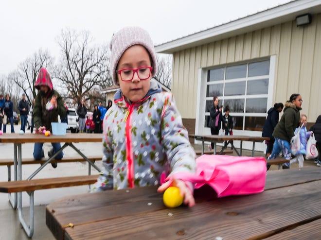 Ana Lucia Pavlovich, 6, of Hartland, scoops up a candy-filled egg during the annual Okauchee Lions Easter Egg Hunt at Lions Park on Saturday, March 30, 2024. The free family event is hosted by the Okauchee Lions Club.