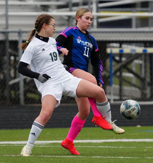 Kettle Moraine Lutheran's Ellie Ericson (19) battles for possession against Waukesha West's Abby Arps (11) during the match at Waukesha West on Saturday, March 30, 2024.