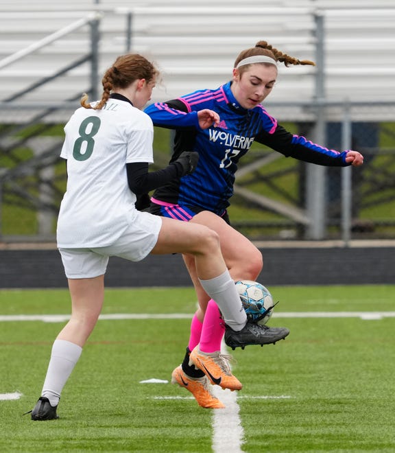 Kettle Moraine Lutheran's Rowan Bell (8) battles for possession against Waukesha West's Brynna Panlener (17) during the match at Waukesha West on Saturday, March 30, 2024.