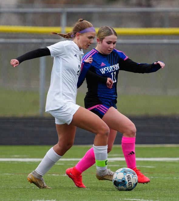 Kettle Moraine Lutheran's Ava Zarling (21) battles for possession against Waukesha West's Abby Arps (11) during the match at Waukesha West on Saturday, March 30, 2024.