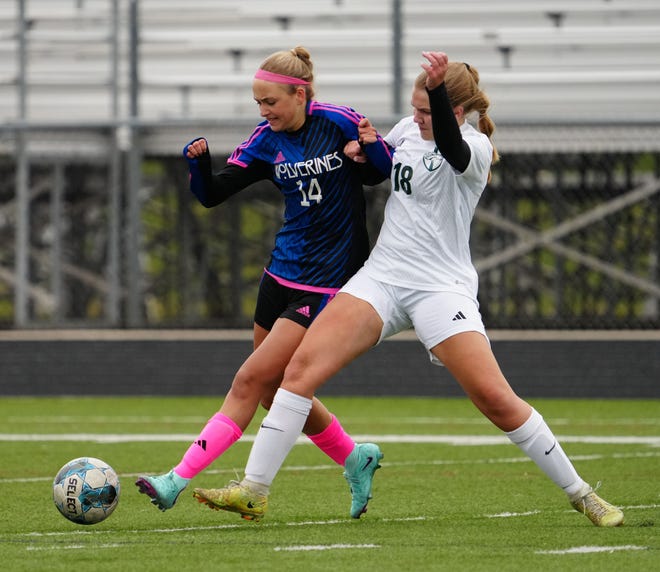 Waukesha West's Ava Labinski (14) battles Kettle Moraine Lutheran's Lydia Zarling (18) during the match at Waukesha West on Saturday, March 30, 2024.