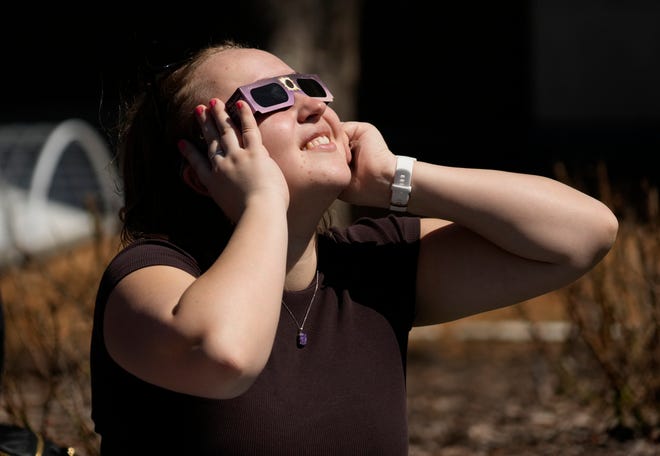 A woman watches the eclipse during a solar eclipse viewing party University of Wisconsin-Milwaukee in Milwaukee on Monday, April 8, 2024.