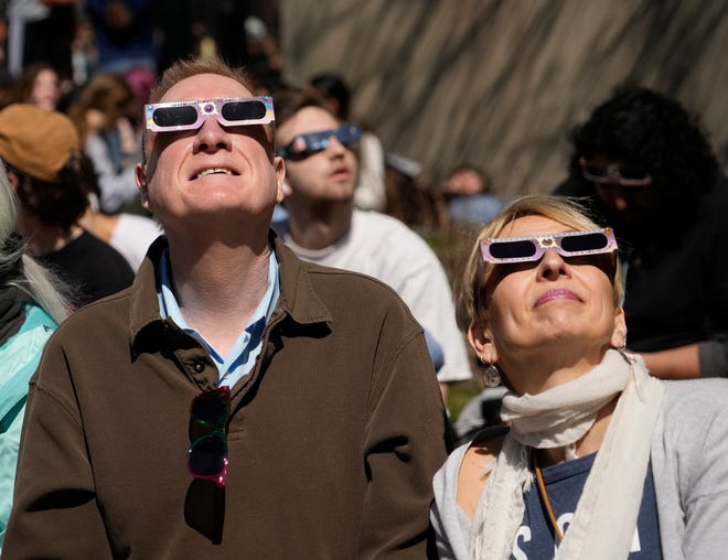 People watch the solar eclipse during a solar eclipse viewing party University of Wisconsin-Milwaukee in Milwaukee on Monday, April 8, 2024.