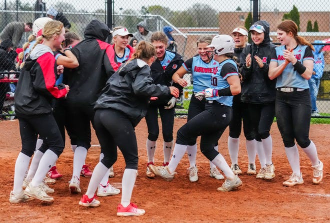 Teammates cheer on Arrowhead's Ashley Gilroy (20) after her walk-off 2-run home run secures a 10-8 victory in extra innings against Oconomowoc, Tuesday, April 16, 2024.