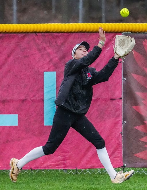 Arrowhead center fielder Jacquelyn Cox (11) pulls in a fly ball at the fence during the game at home against Oconomowoc, Tuesday, April 16, 2024.