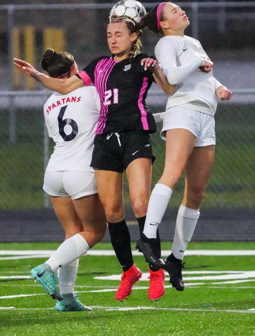 Kettle Moraine's Eiley Henderson (21) battles for a header with Brookfield East's Ava Tetzlaff (22) during the match at Kettle Moraine, Thursday, April 18, 2024.