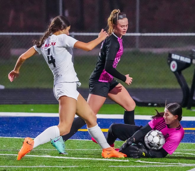 Kettle Moraine keeper Erika Panella (99) blocks a shot by Brookfield East's Braelyn Hundt (4) during the match at Kettle Moraine, Thursday, April 18, 2024.