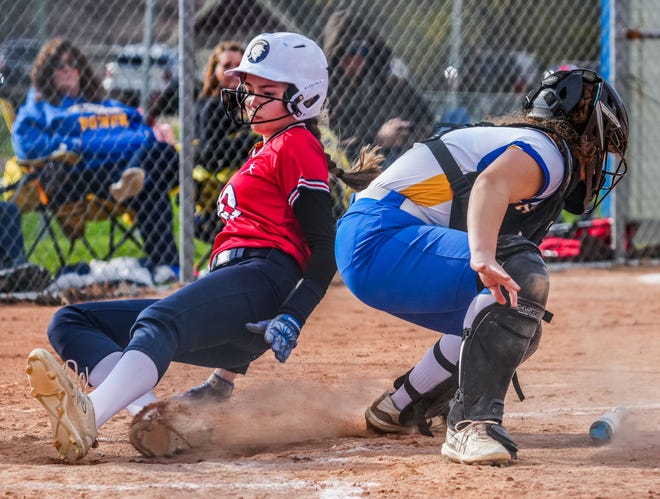 Brookfield East's Elizabeth Lacey (10) beats the tag at home by Germantown catcher Kennedy Bennett (4) during the game at Germantown, Tuesday, April 23, 2024. Germantown won 4-2.